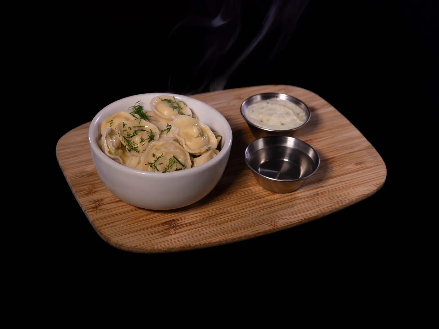 Pelmeni, chicken dumplings with fresh dill, dill cream and house vinegar